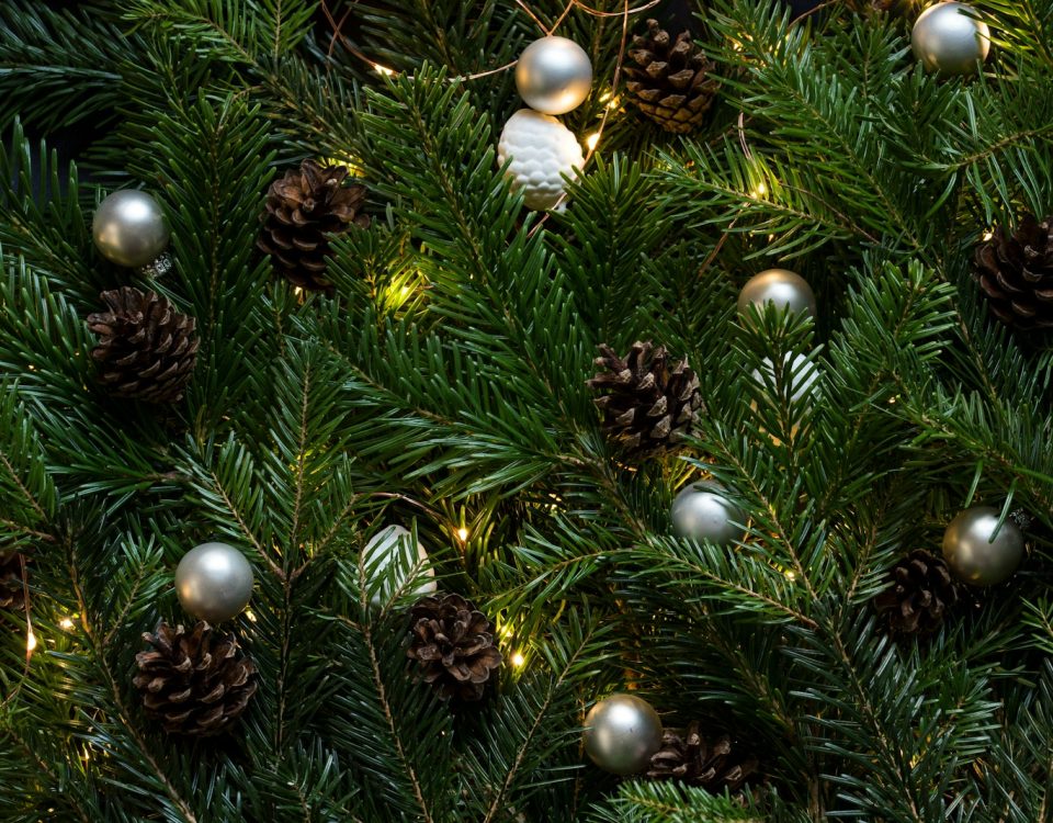 closeup photo of Christmas tree with ornament and lighted lights